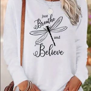 Cute tunic, long sleeved white top with black writing, button detail on cuffs.